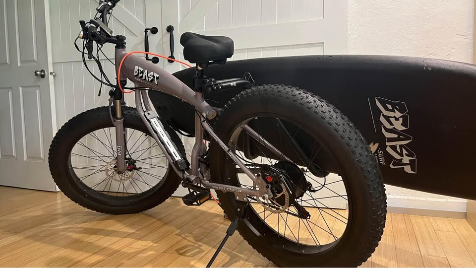 BEAST shortboard rack fitted to a bicycle with a surfboard