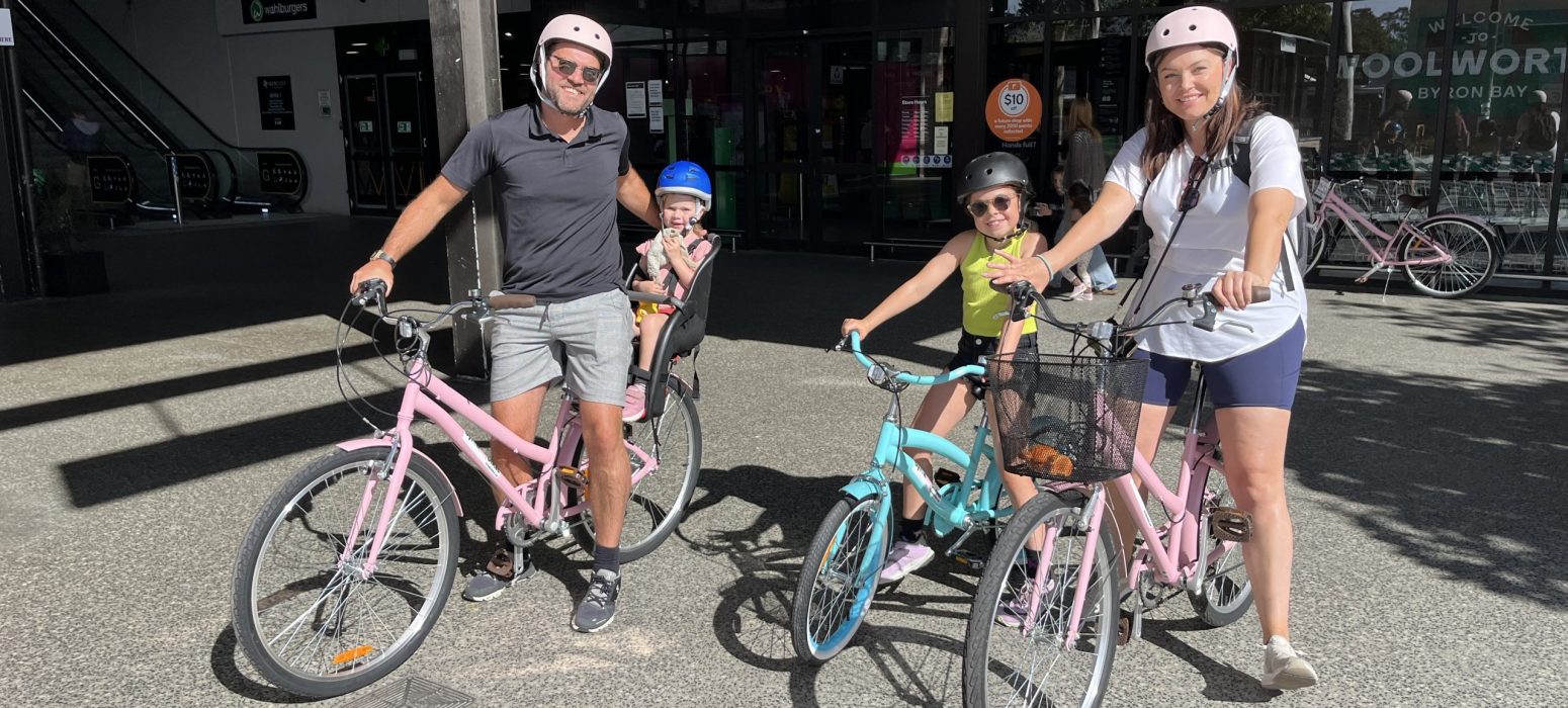 familly picking up bikes at the mercato on byron
